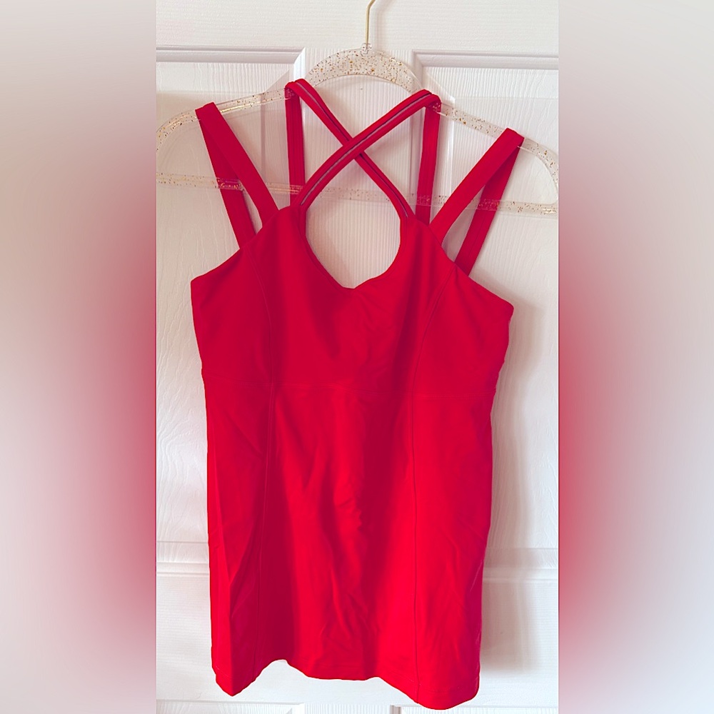 A rare Lululemon tank top, size 10, in a vibrant red-orange hue. Show Stopper!